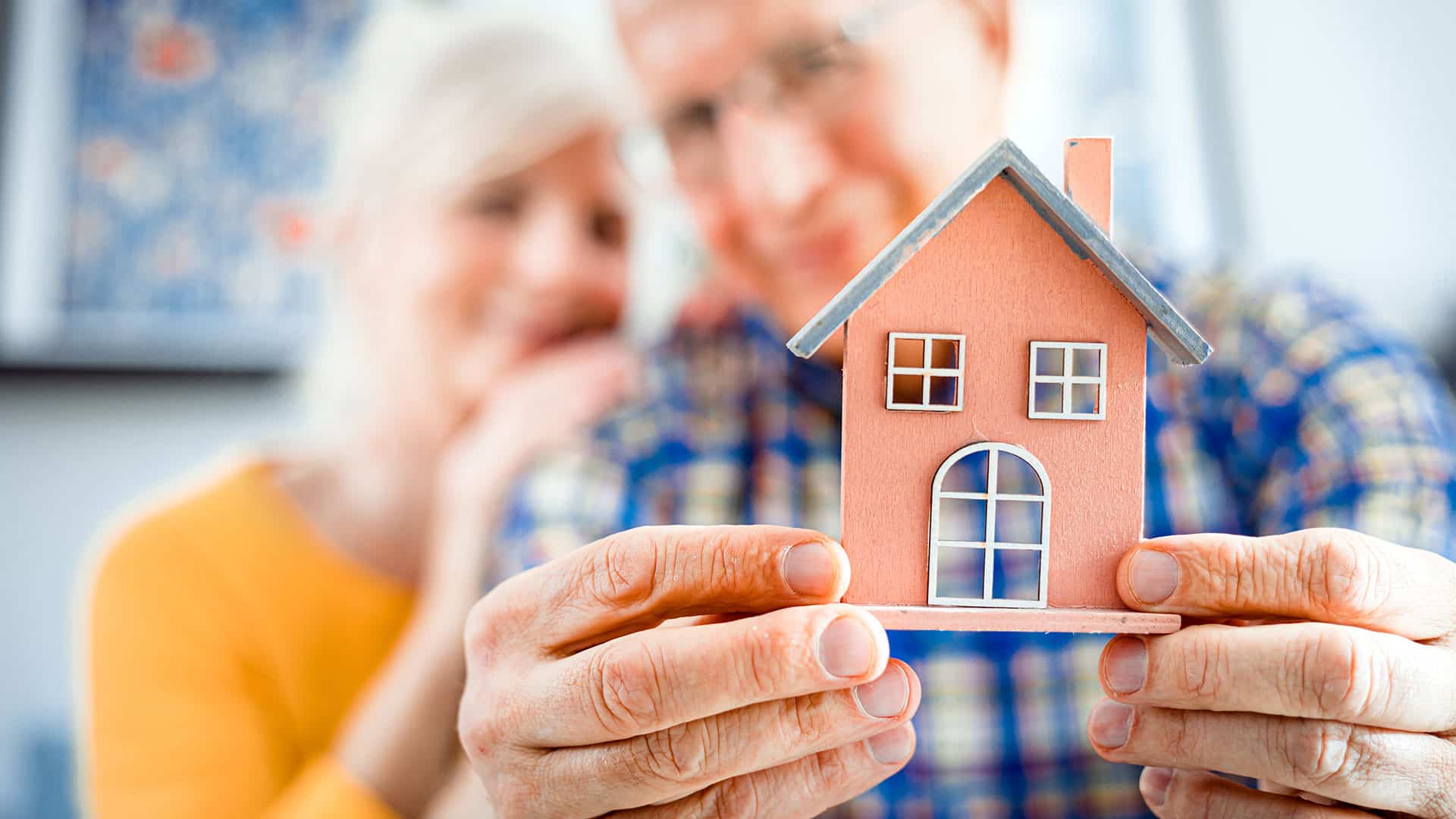 Older Couple With House